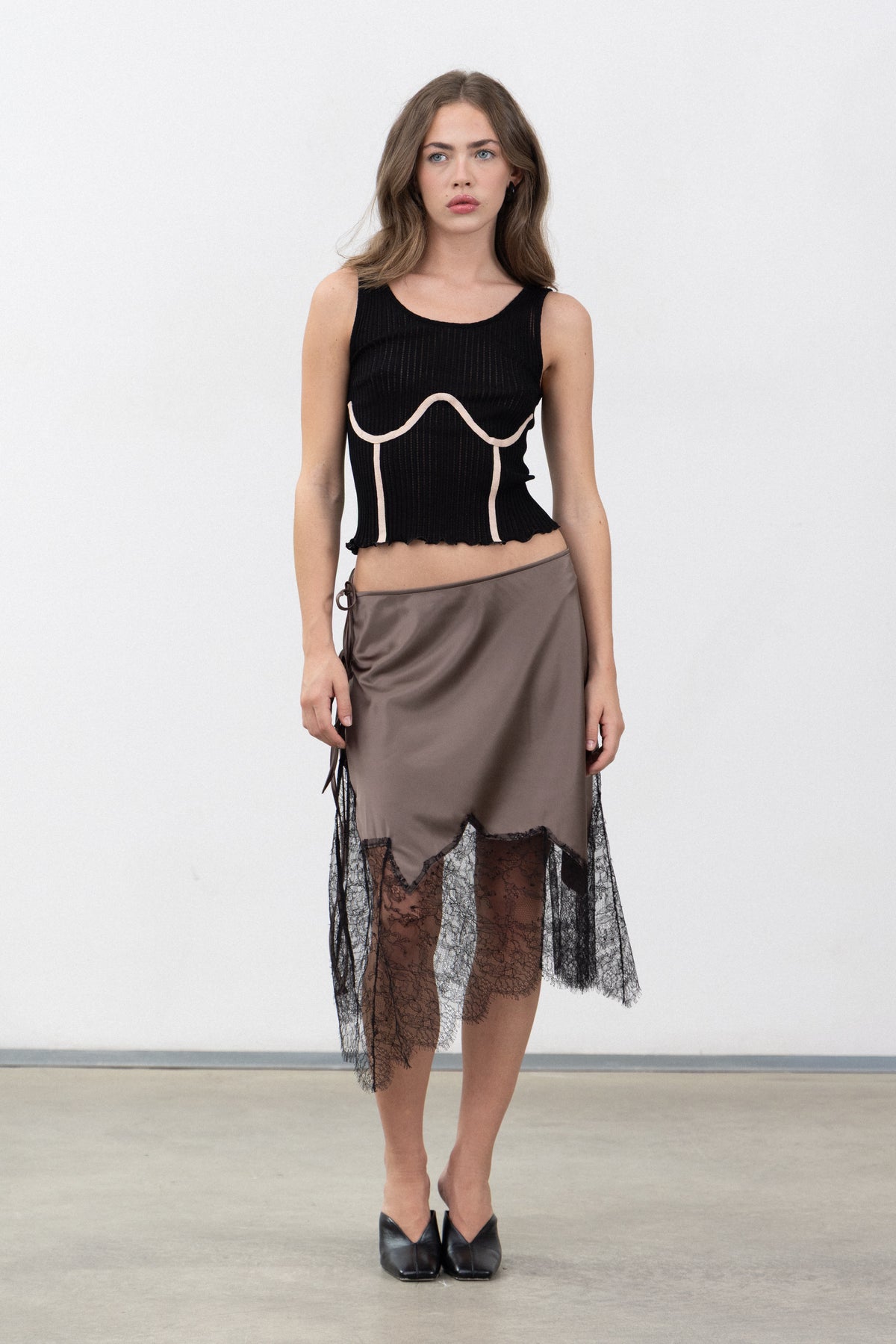 Full-length view of the Inferno Taupe satin and lace skirt styled with the Dimenticato Black Top