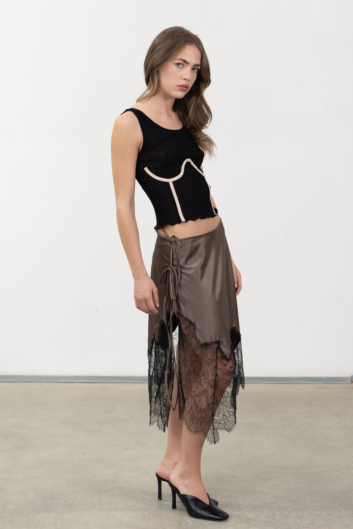 Model wearing the Inferno Taupe Skirt, showing the asymmetric wrap and uneven lace hem
