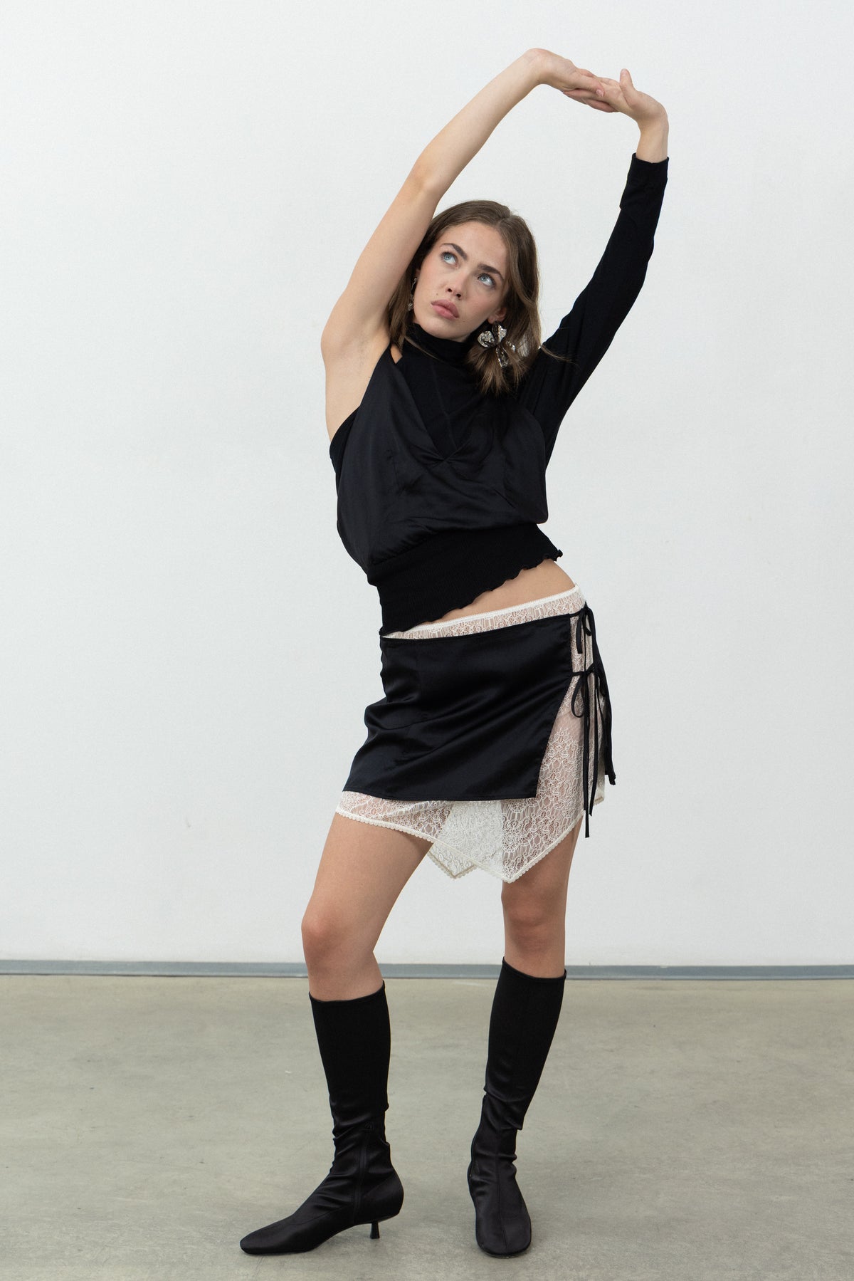 Full-length view of the Doppia Skirt worn with knee-high boots