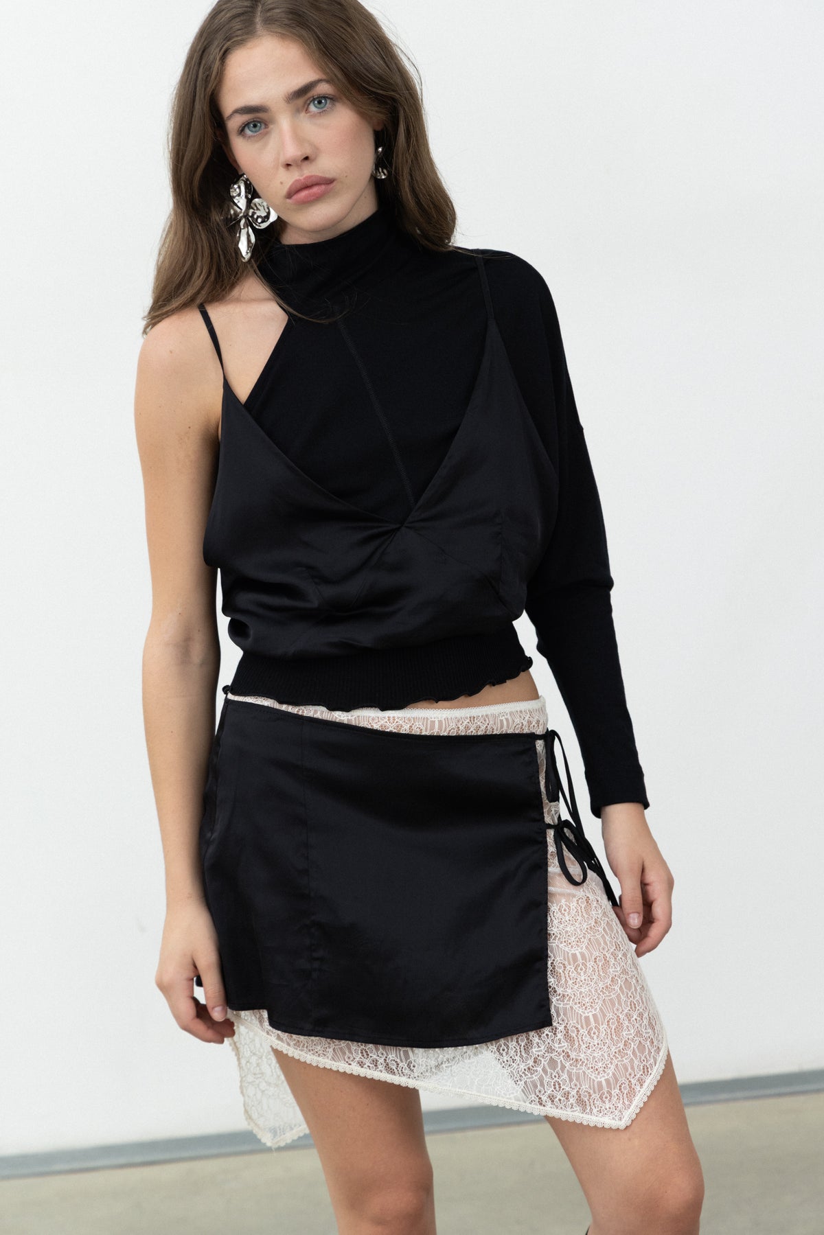 Close-up of the Doppia Skirt showing the black satin layer over the ivory lace