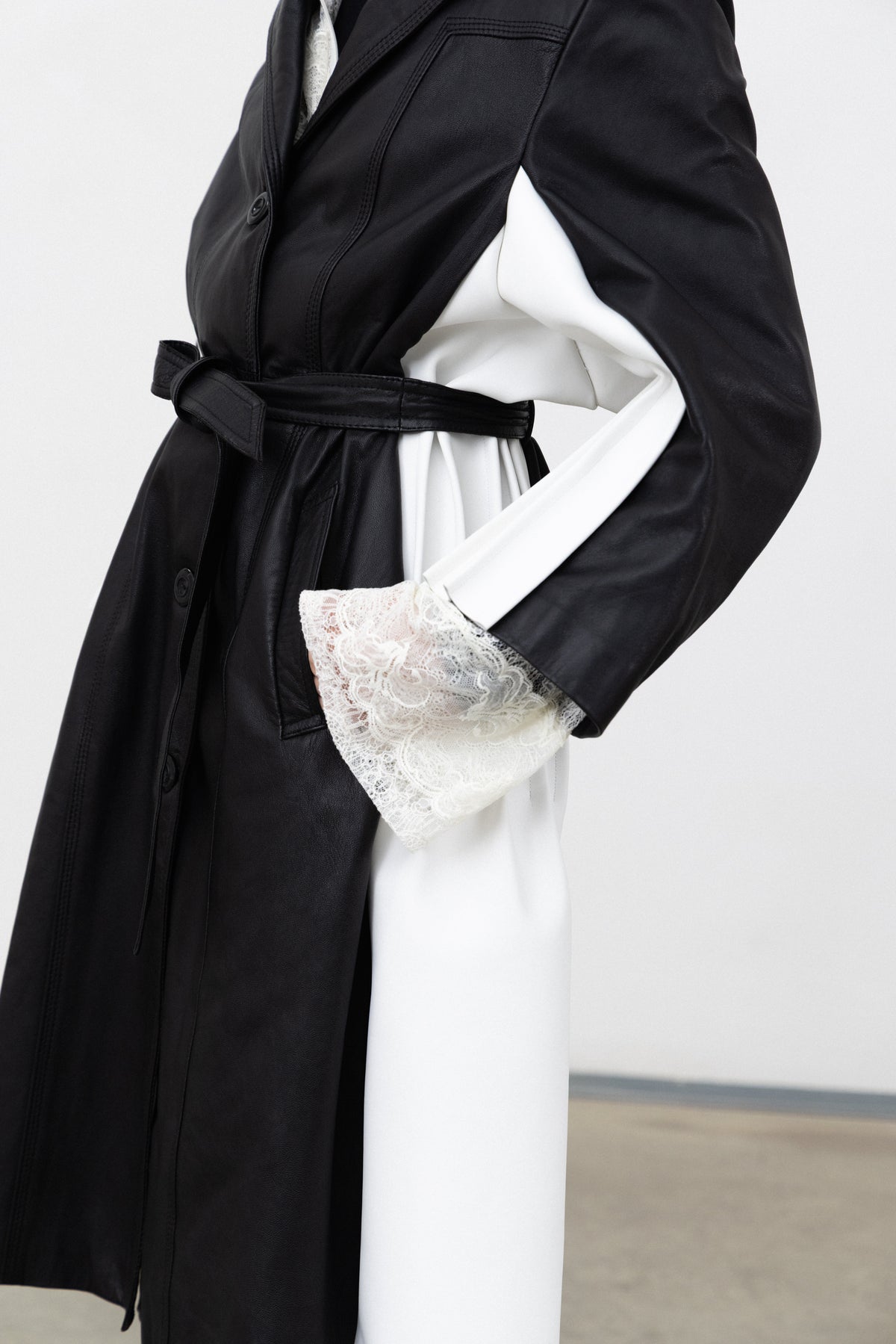 Detail of the white leather under-sleeve insert on the Luxifer black leather trench
