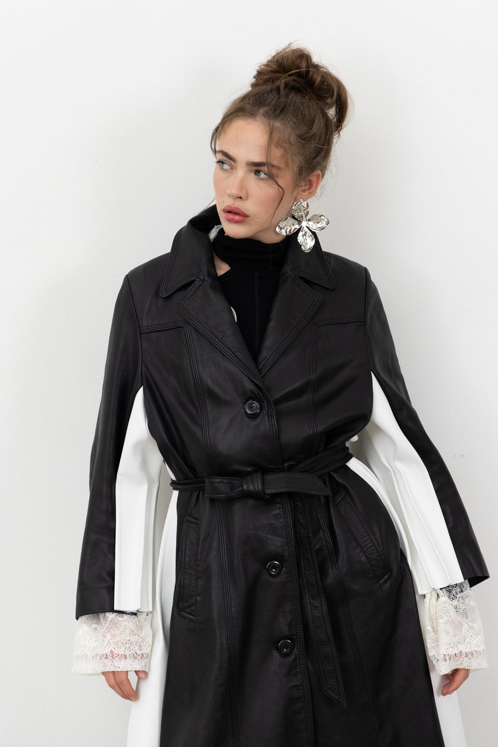 Front view of the Luxifer trench showing the white leather panels along the sleeves