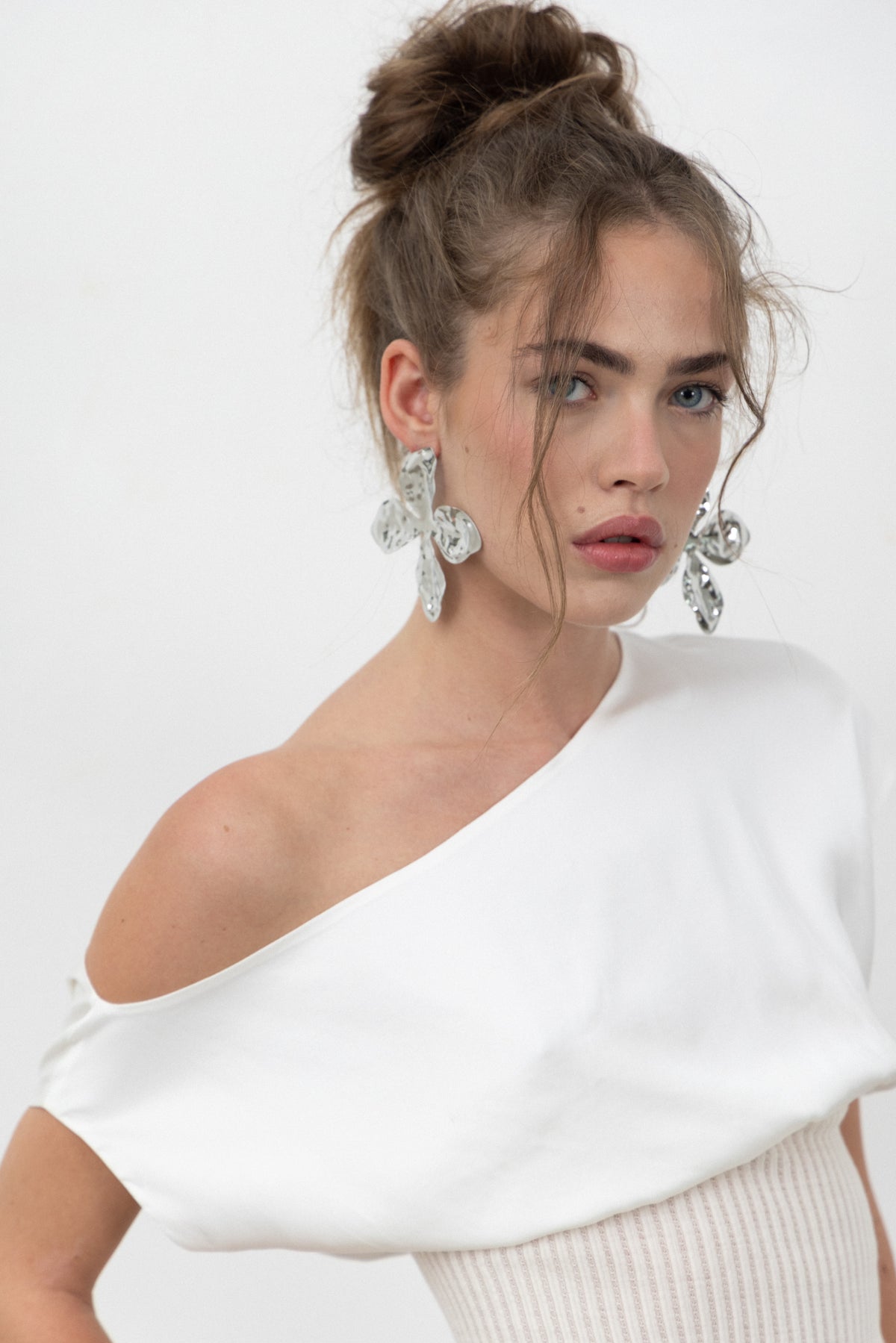 Close-up of the Lux Top's satin boat neckline worn off one shoulder