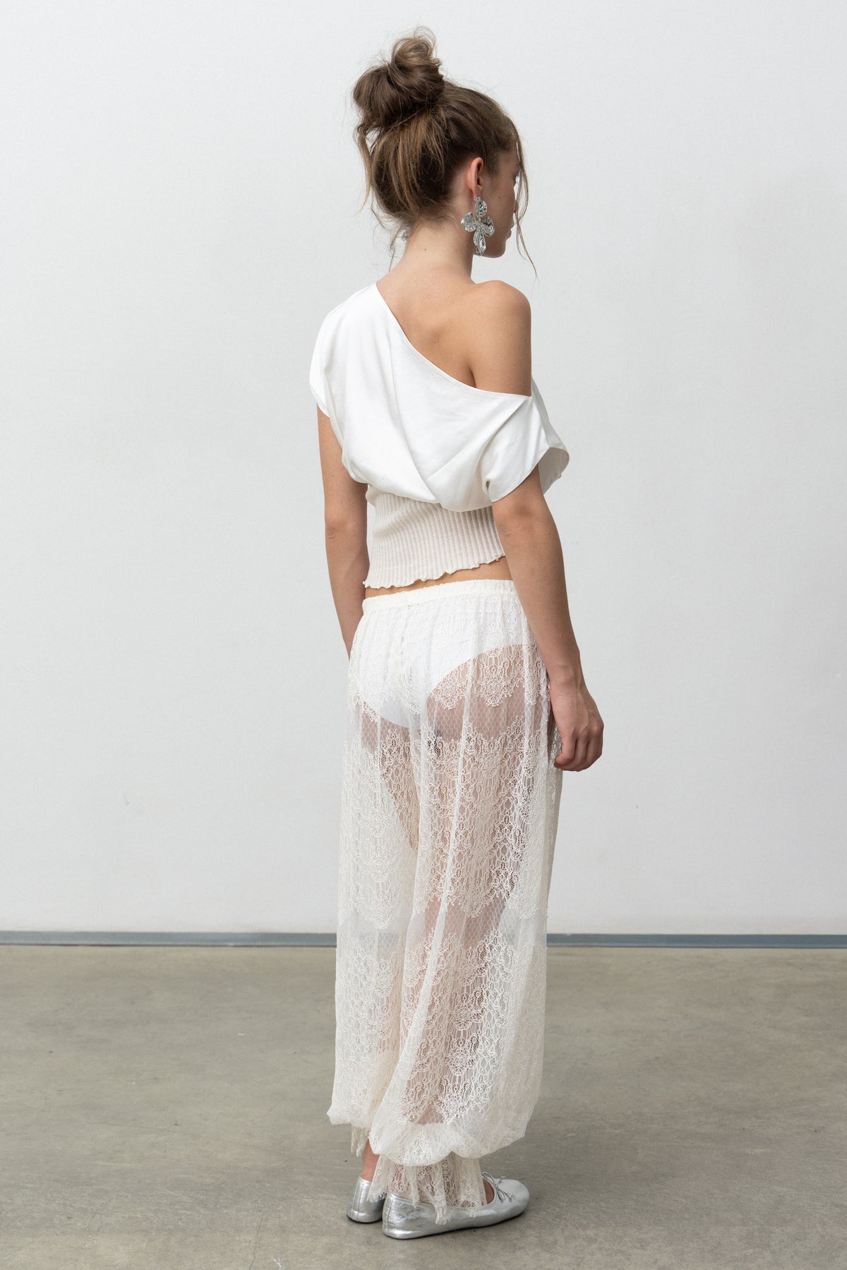 Back view of the Lux Top showing the draped satin bodice and rib waistband