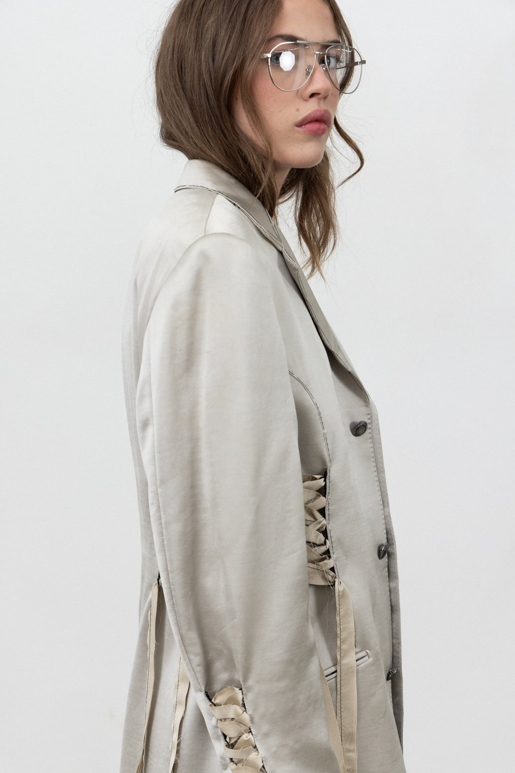Side view of the champagne Sacro Blazer showing the lacing along the side