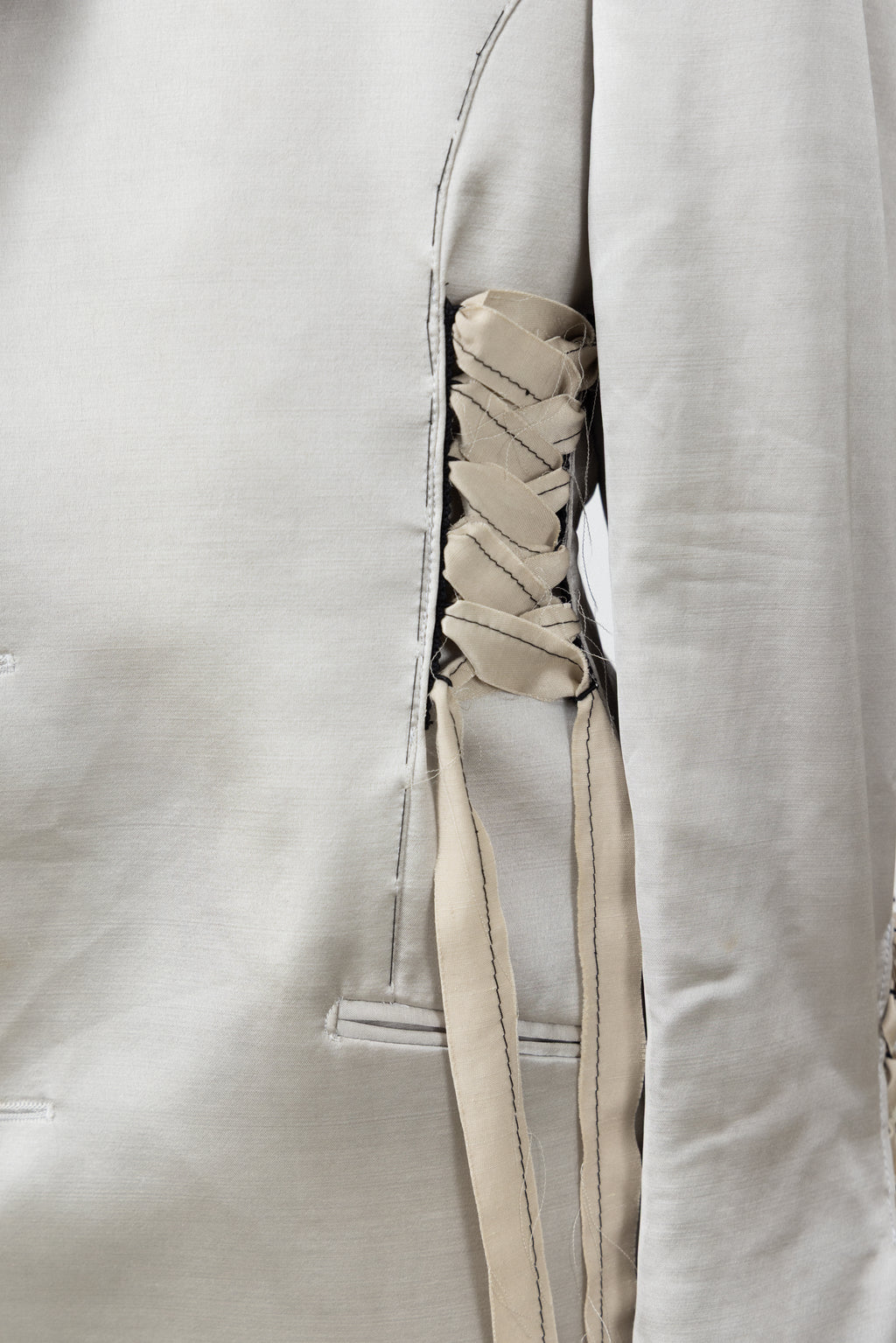 Close-up of the satin and ribbon lacing on the Sacro Blazer