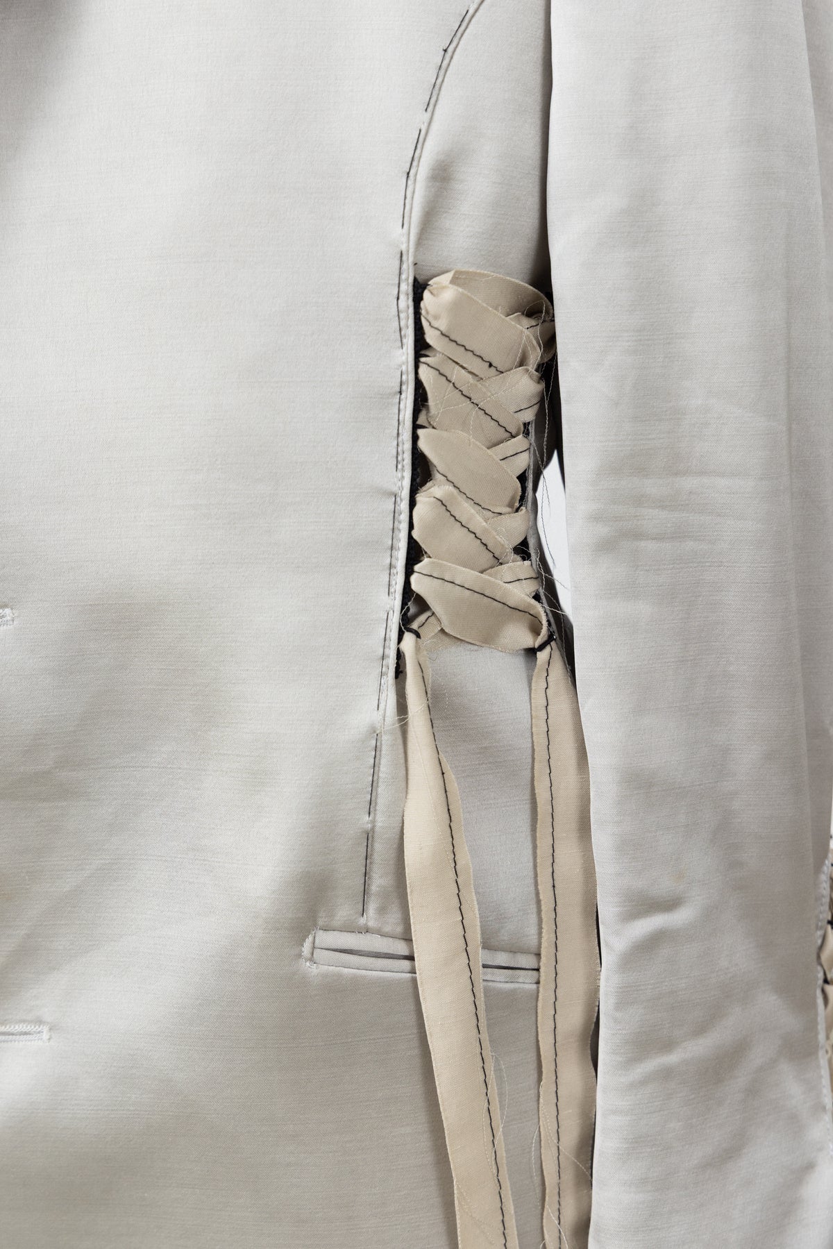 Close-up of the satin and ribbon lacing on the Sacro Blazer