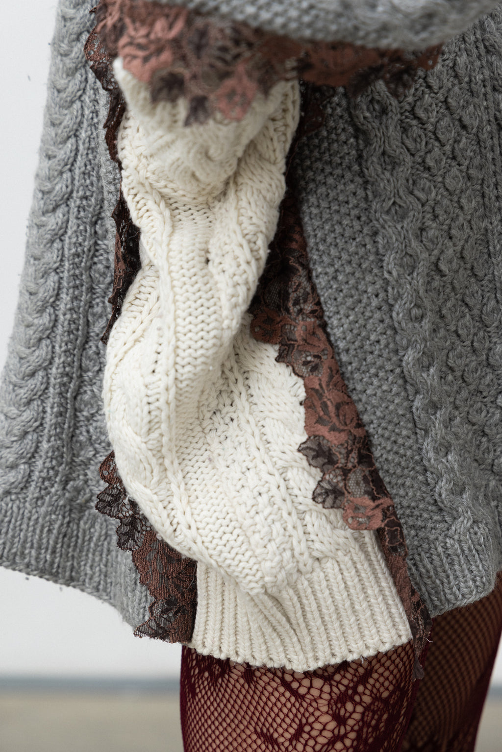 Detail of the violet lace inserted along the joins of the Dimenticato Cardigan