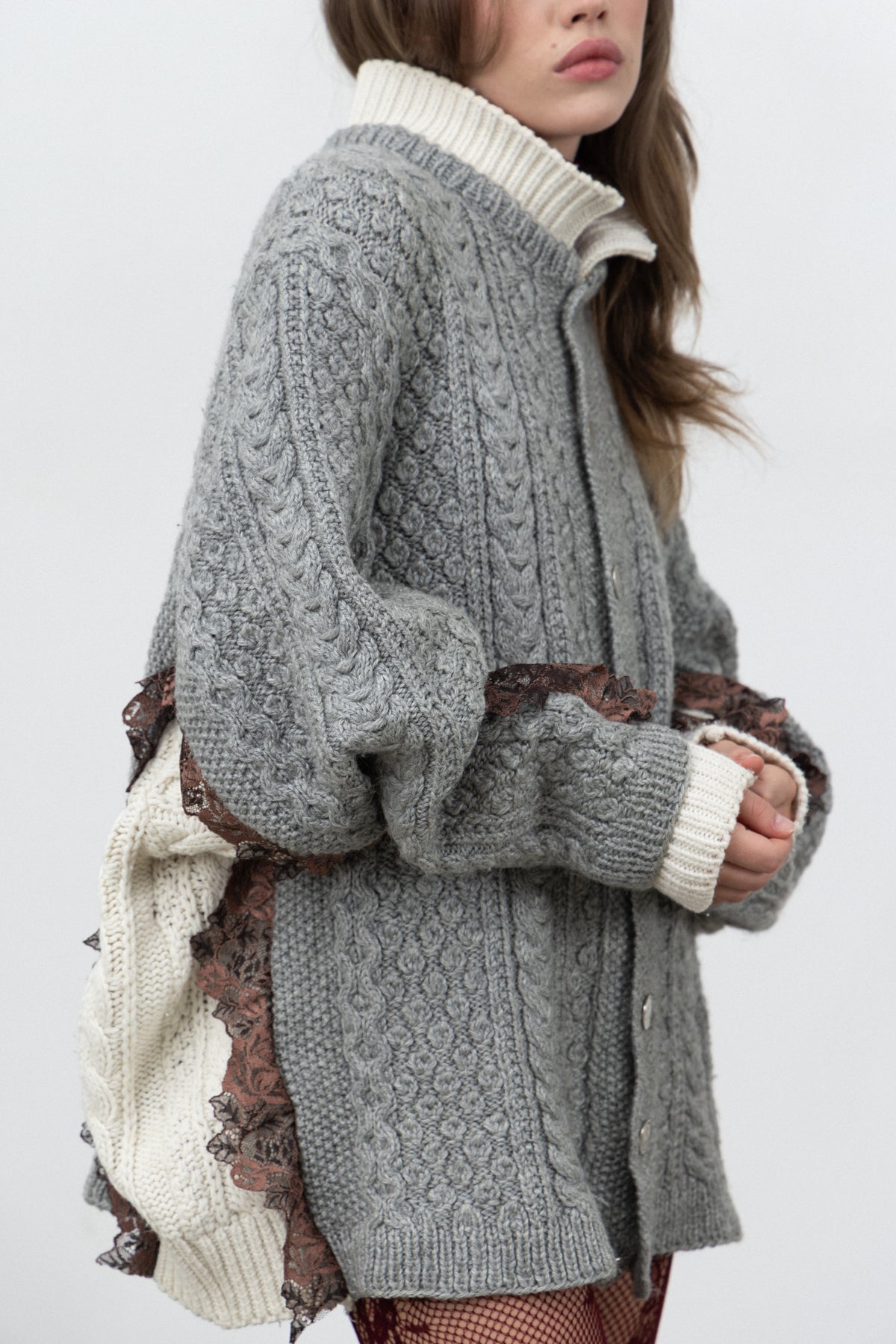 Side view of the Dimenticato Cardigan showing the ivory knit and violet lace joins
