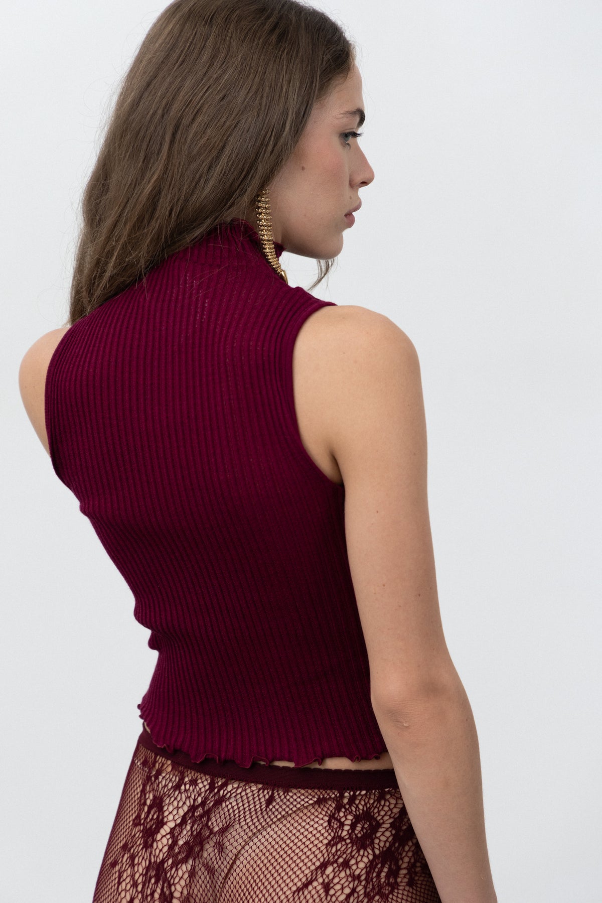 Back view of the Dimenticato Malbec Top showing the merino and silk rib knit and lettuce-edge hem