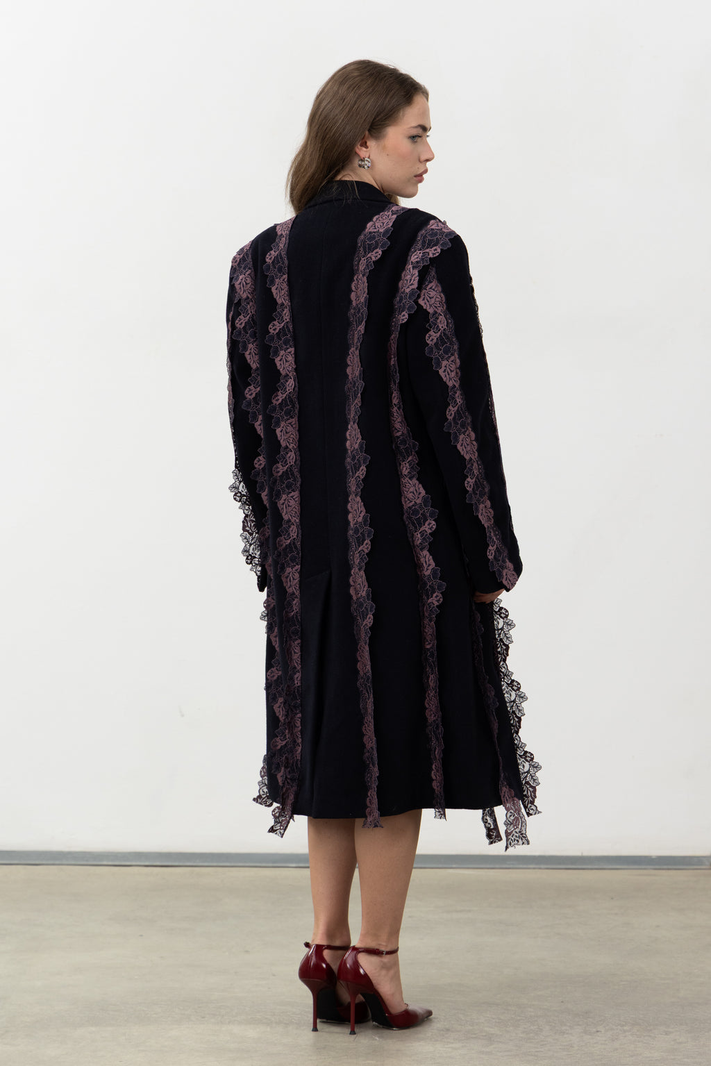 Back view of the Rinascimento Coat with vertical purple lace bands