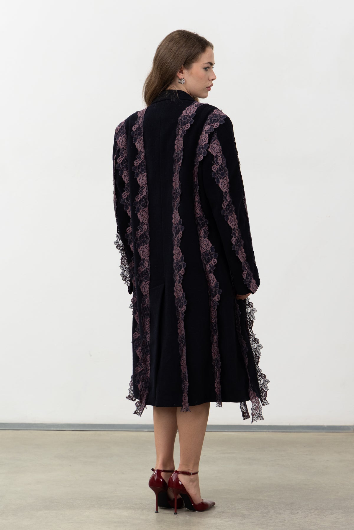 Back view of the Rinascimento Coat with vertical purple lace bands