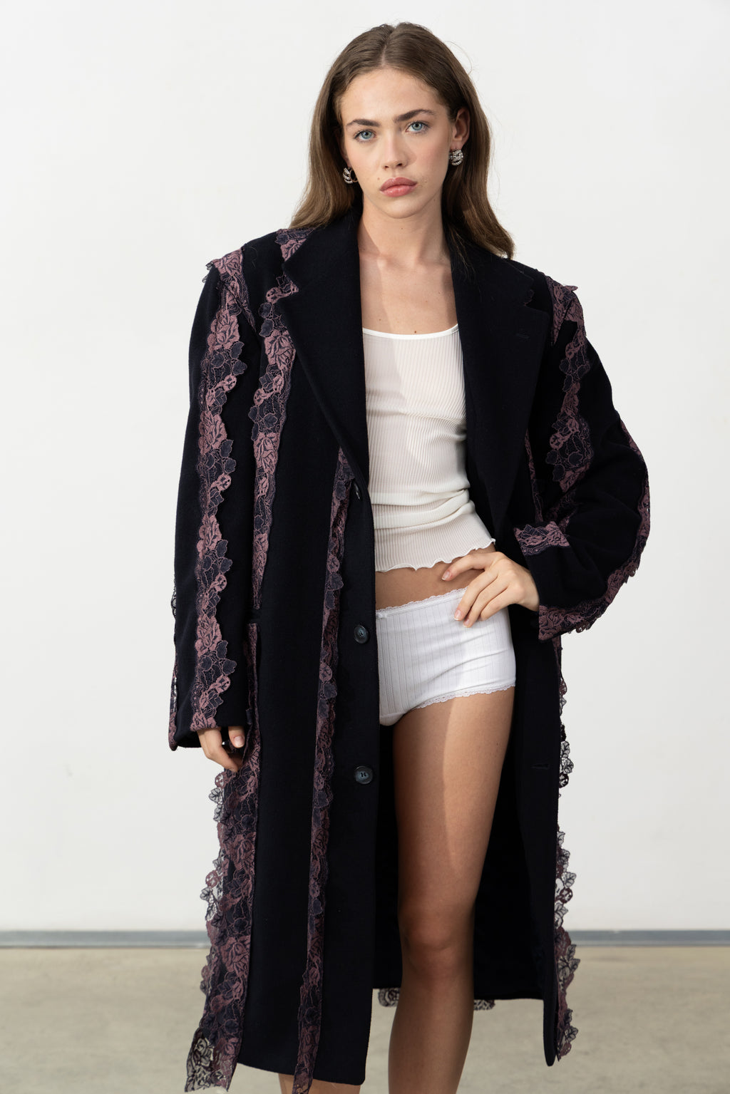 Model wearing the Rinascimento Coat open over a white top