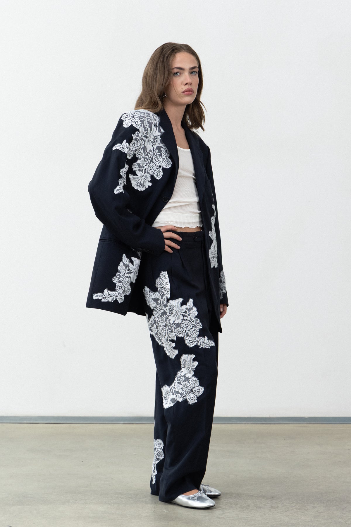 Side view of the Allegoria trousers worn with the matching blazer