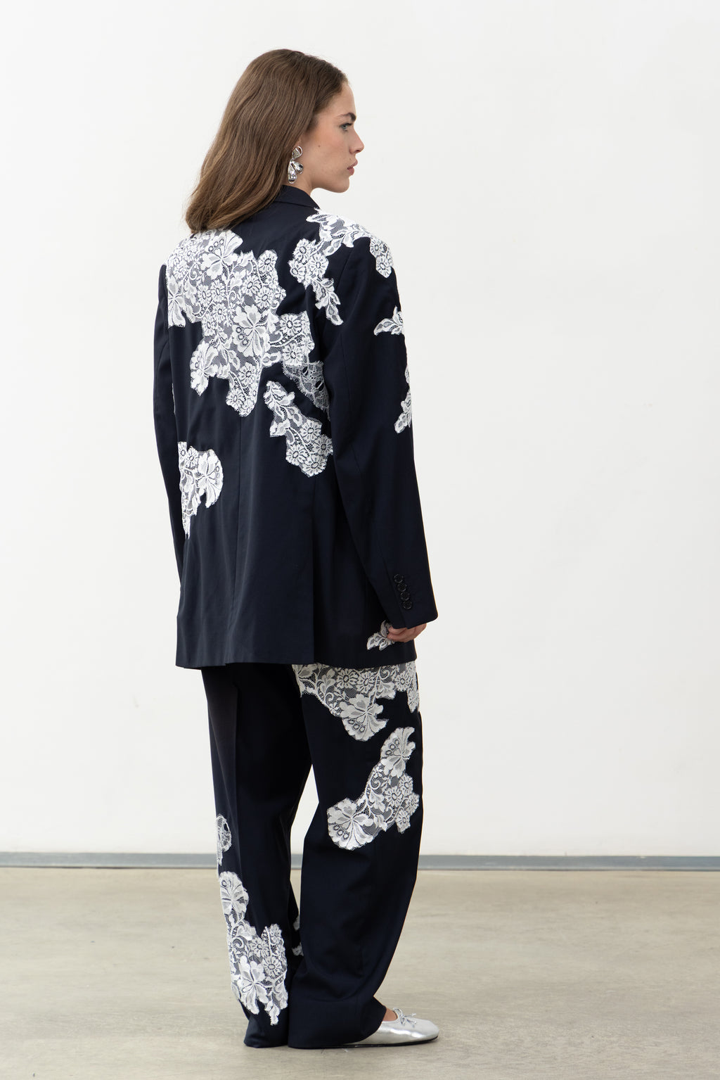 Back view of the Allegoria navy wool blazer with white lace