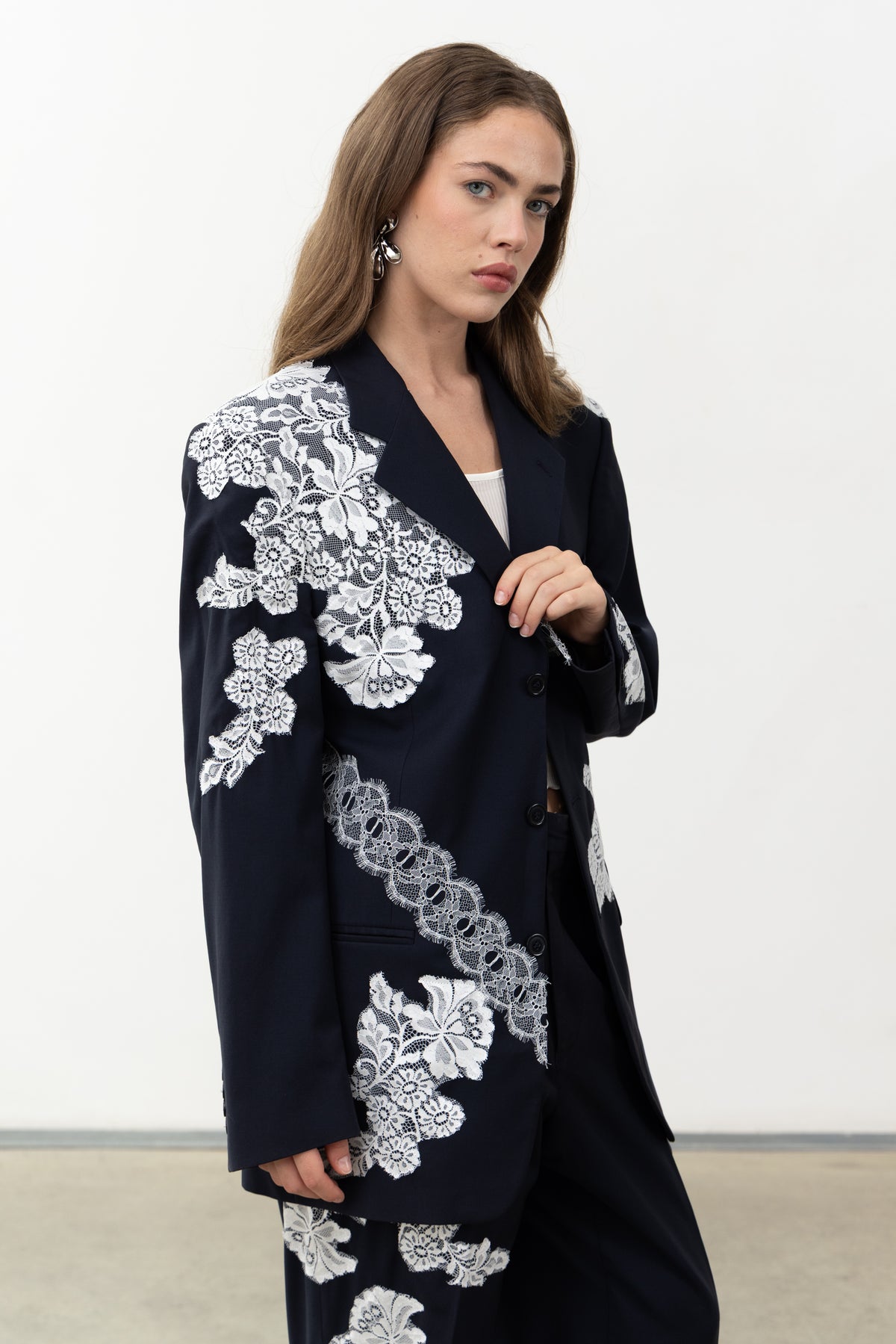 Three-quarter view of the Allegoria Blazer showing different white lace textures