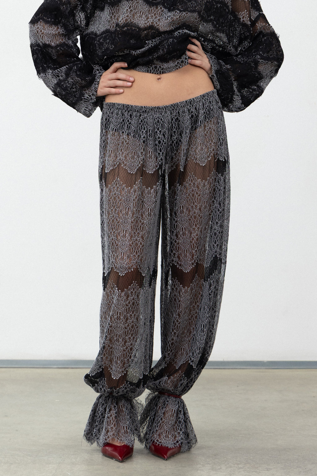 Front view of the Sbagliato Dark Pants showing the sheer black and white lace