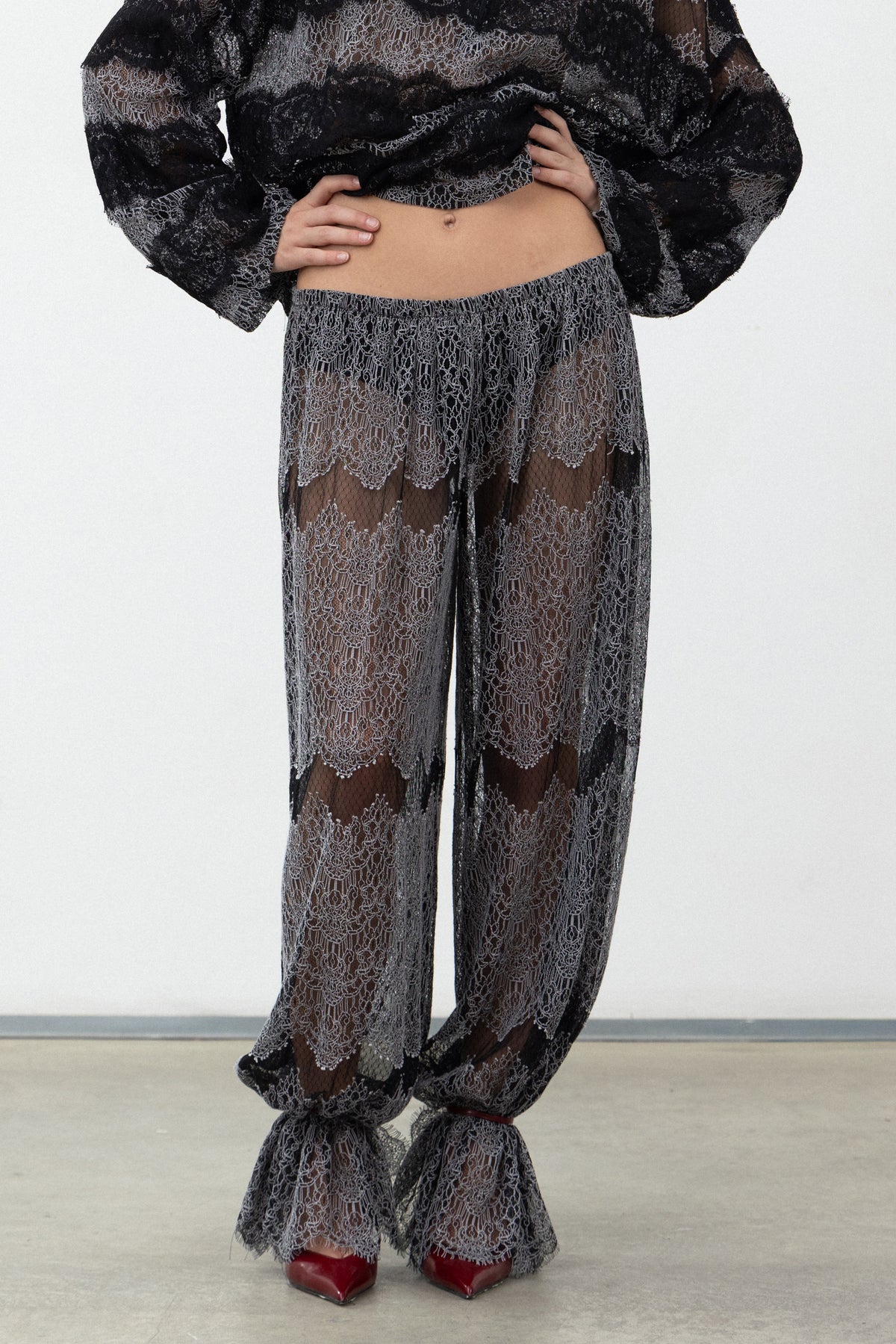 Front view of the Sbagliato Dark Pants showing the sheer black and white lace