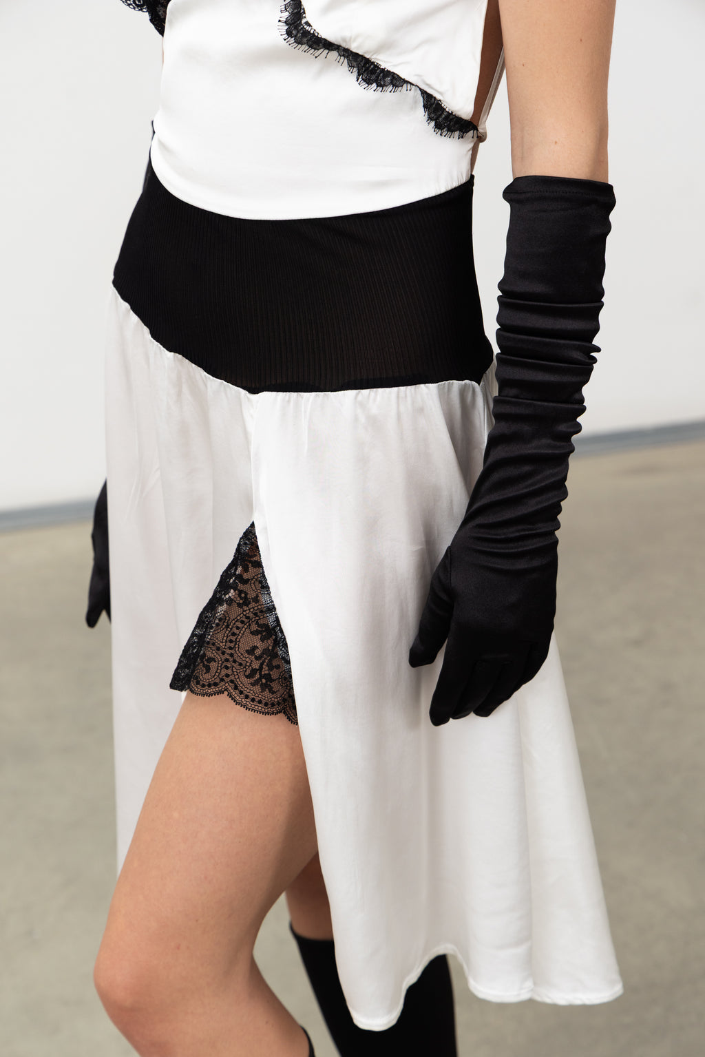Detail of the silk rib-knit waist and lace-lined side slit on the Sacro Dress