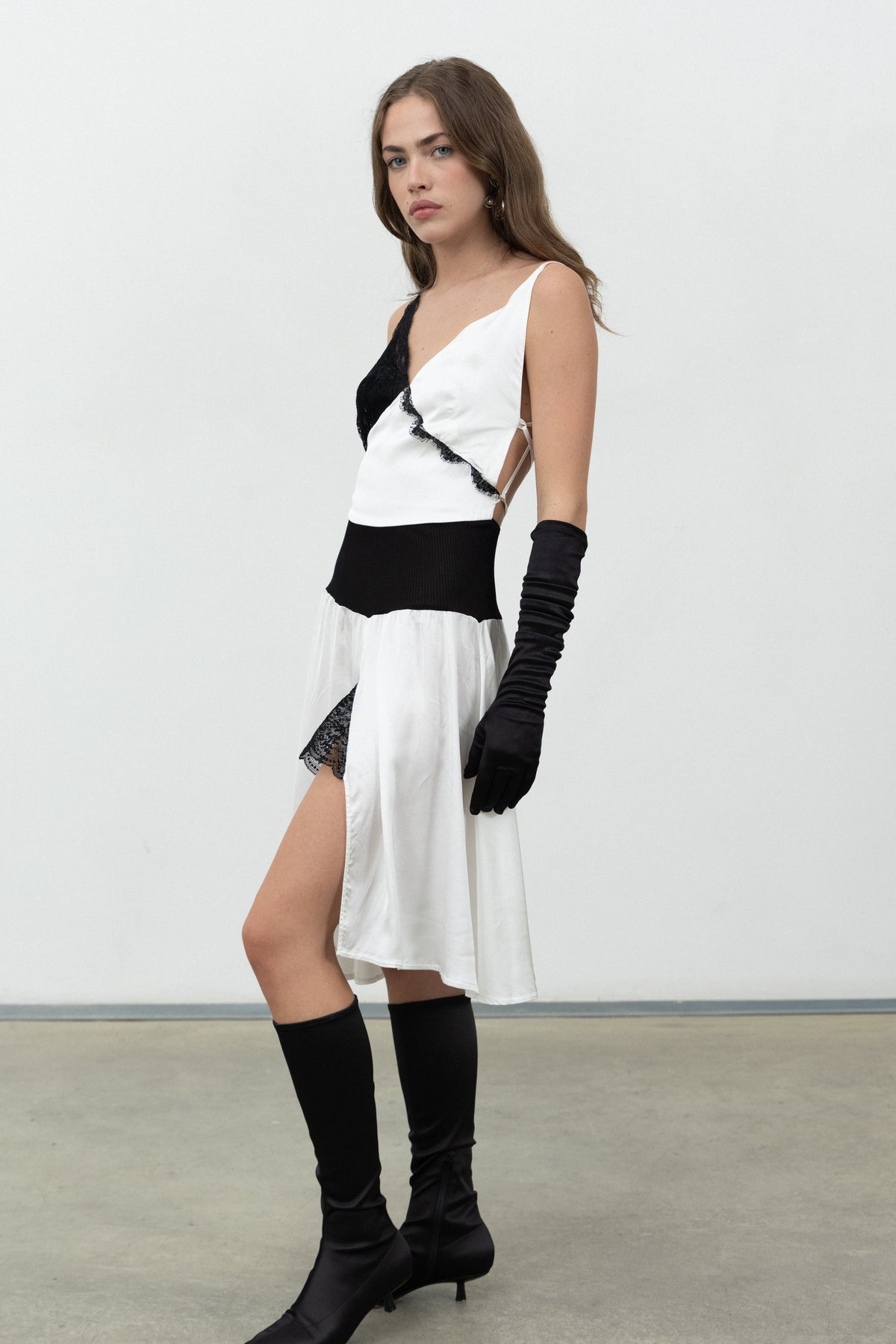 Side view of the white satin Sacro Dress showing the side slit